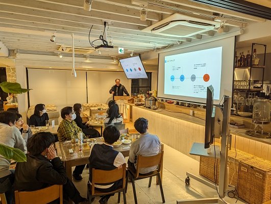 原宿の拠点で行われたセッション。スクリーンに資料を投影し、参加者が着席して聞いている様子